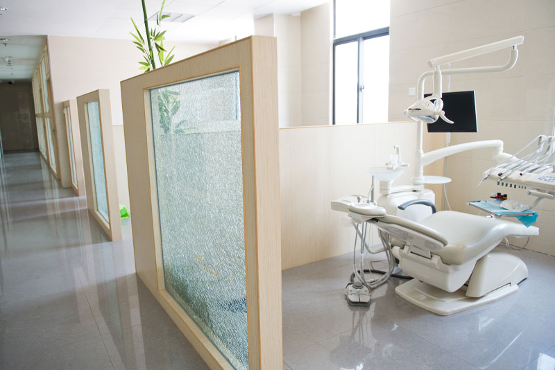A treatment room at the practice, screened by a frosted-glass partition