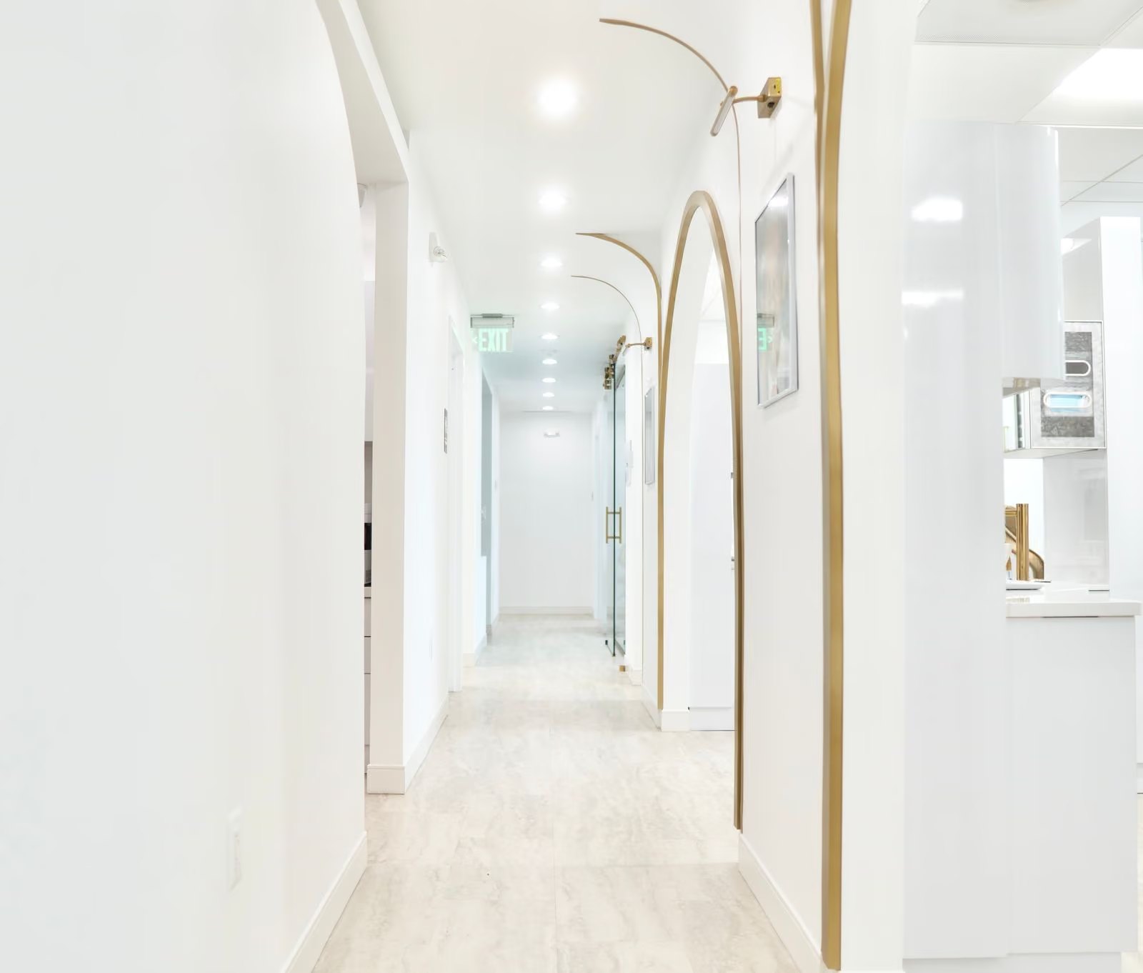 The corridor between treatment rooms, lined with gold arch detailing