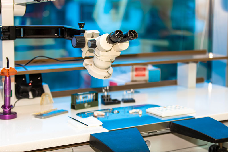 A stereo microscope over the bench in the practice's in-house laboratory